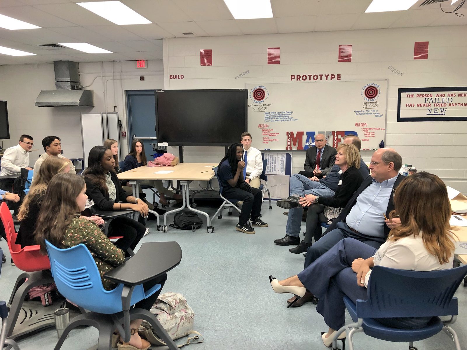 Students and Netarus staff in a classroom discussion at a Virginia Beach high school