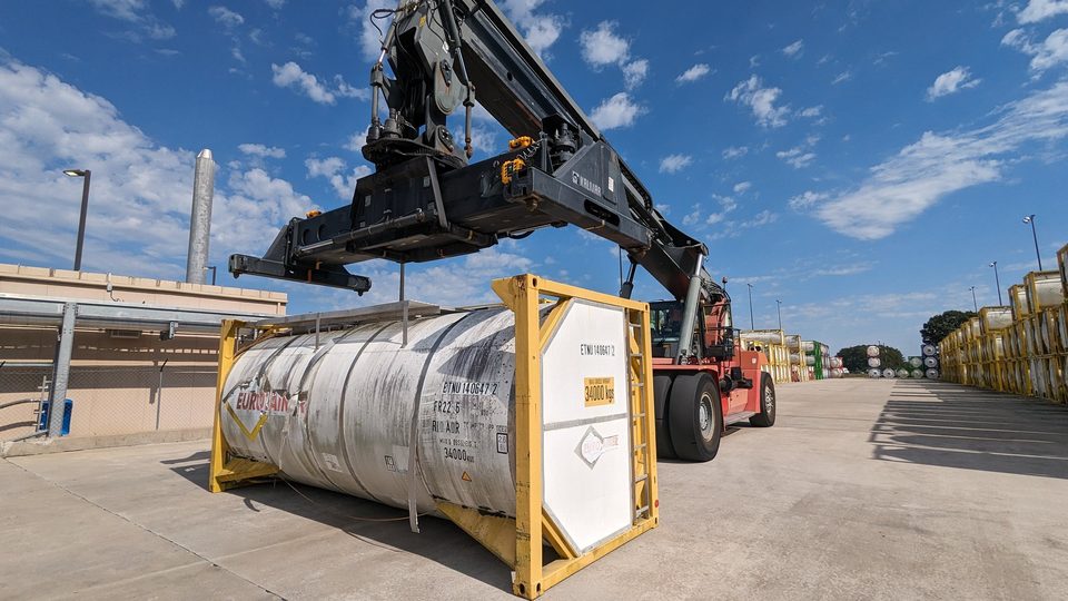 Reach stacker fitted with a HoistCam lifting an ISO tank container in a container yard