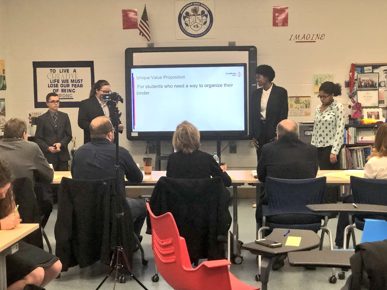 Virginia Beach high school students presenting to a panel in a classroom
